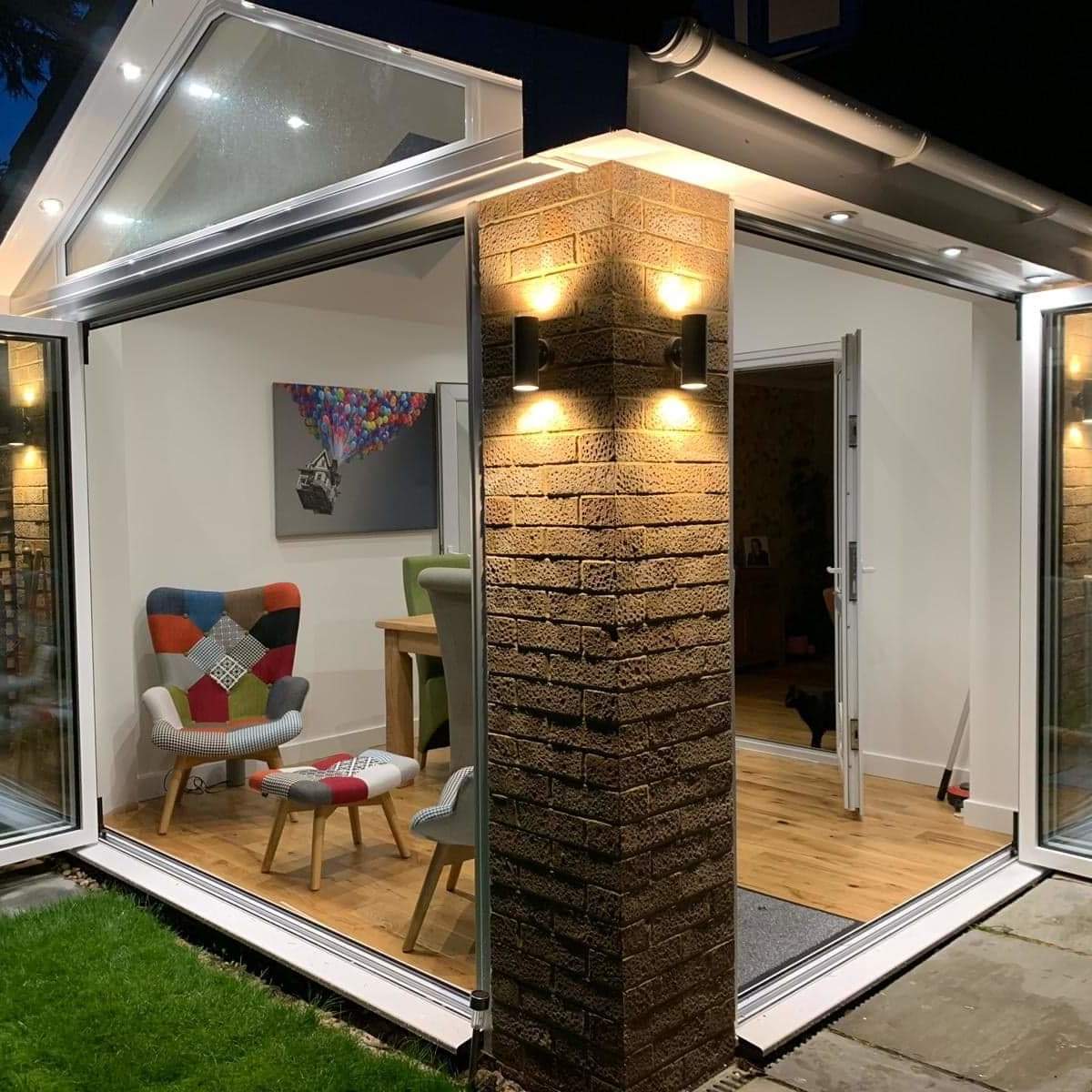 Right hand corner of a new conservatory with downlighters and open doors